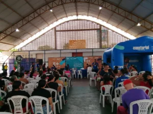 Mão segurando lâmpada com família consultando conta de luz, simbolizando a Tarifa Social e atualização cadastral.
