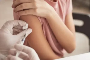 Mãe com filho em posto de saúde preocupa-se com vacinação e benefício social