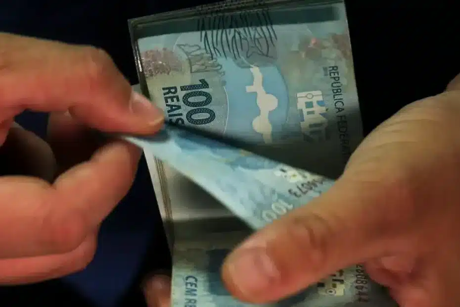Trabalhador recebe comprovante de pagamento do abono salarial PIS/Pasep em agência bancária