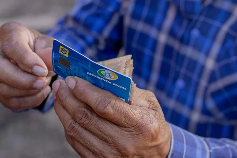 Idoso sorri ao conferir pagamento do INSS no celular.