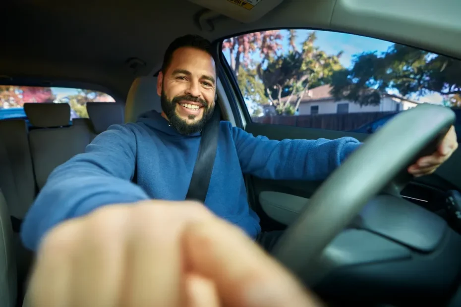 Motorista de aplicativo sorrindo, visualizando informações sobre cashback no celular dentro de um carro novo.